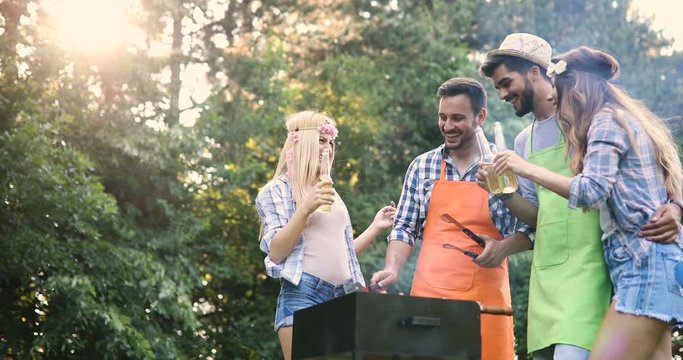 Friends spending time in nature and having barbecue