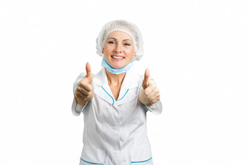 Cheerful doctor raised thumbs up. Professional and smiling female doctor with thumbs up over white background.