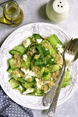 Cucumber salad with quinoa and feta cheese.Top view.
