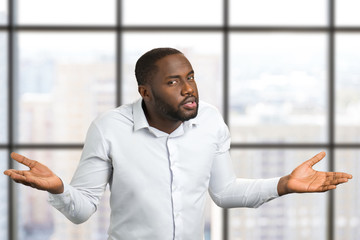 Black man with hands in different sides. Man with hands raised to the sides of the body. Facial expressions and body language.