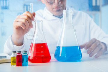 Funny mad chemist working in a laboratory