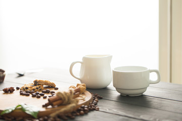 hot black coffee with cookies and beans in cafe