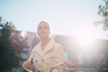 Woman biking to work in early morning