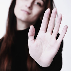 Girl showing stop hand sign gesture (Body language, gestures, psychology)