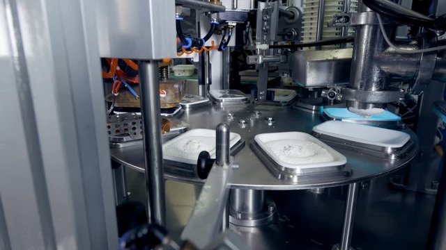 Milk products being made by factory equipment.