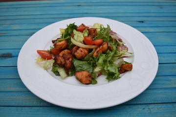 Fresh vegetable salad, healthy food, tomatoes and salad leaves. Healthy chicken salad with fresh vegetables