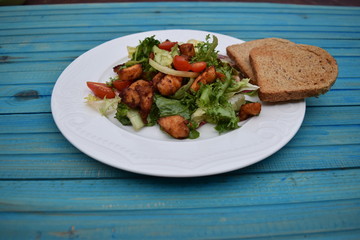 Fresh vegetable salad, healthy food, tomatoes and salad leaves. Healthy chicken salad with fresh vegetables