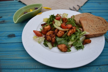 Fresh vegetable salad, healthy food, tomatoes and salad leaves. Healthy chicken salad with fresh vegetables
