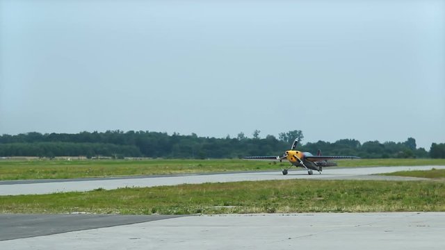 Light aircraft with propeller moving along runway, getting ready to take-off