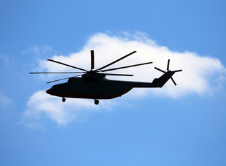 Naklejka na ściany i meble Side view of transport helicopter in flight.