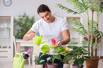Young man in gardening concept at home