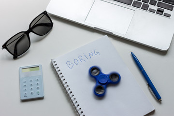work desk with laptop notebook and spinner