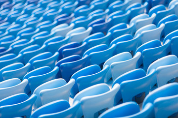 Rows of blue seats at football stadium. Convenient sitting for all