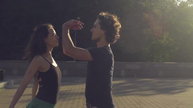 Young couple dancing on the square