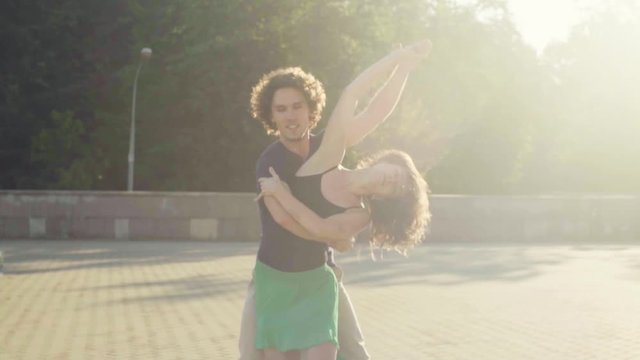 Young couple dancing on the square