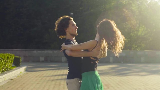 Young couple dancing on the square