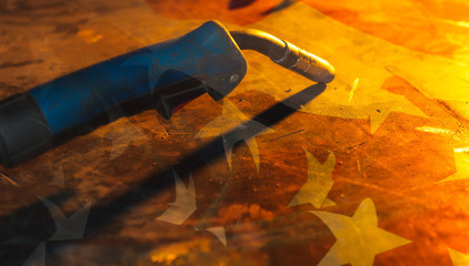 Welder, metal table, bright light from the fire in the smithy