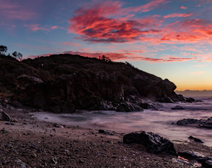 Fototapeta premium Red clouds over the headland