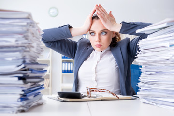 Tired businesswoman with paperwork workload - obrazy, fototapety, plakaty