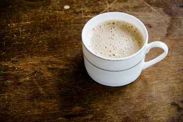 Tea with in a mug or popularly known as Teh Tarik isolated in white view from top.