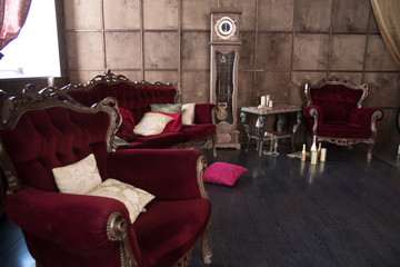 Interior with antique red furniture and clock.