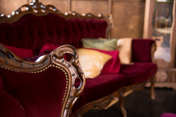 Luxurious antique red sofa with pillows