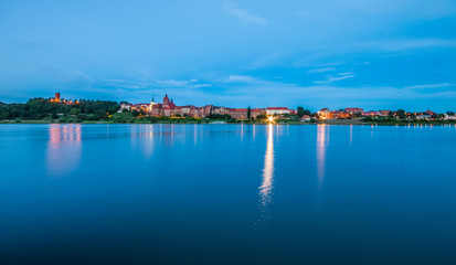 Naklejka na ściany i meble Grudziadz at night with Wisla river, Poland