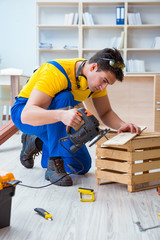 Repairman carpenter cutting sawing a wooden board with an electr