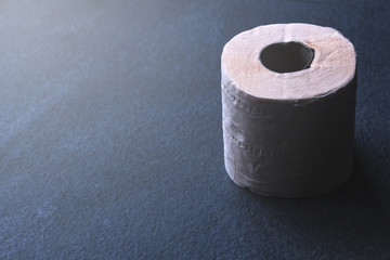 Roll tissue paper on stone floor.