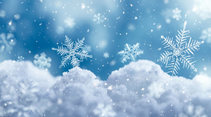 Macro snowflake on snow and fallen defocused snowflakes
