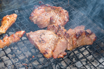 Chicken and pork grill over the small flame. shallow DOF.