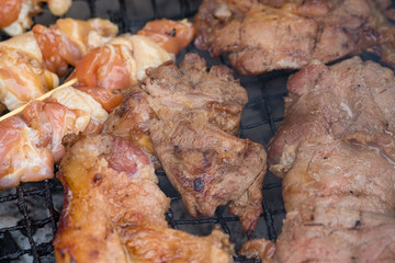 Chicken and pork grill over the small flame. shallow DOF.