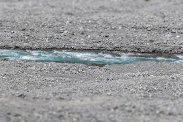 A small blue river flows in the mountainous country of Georgia.