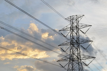 Silhouette of electricity post in evening day. High voltage power line.