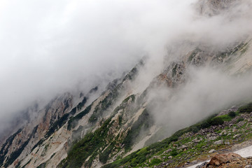 Alpine terrain on Mount Shirouma of the Northern Alps in Japan, a popular mountain for Japanese hikers and climbers and potentially dangerous peak with snow, steep terrain and crevasse like dangers