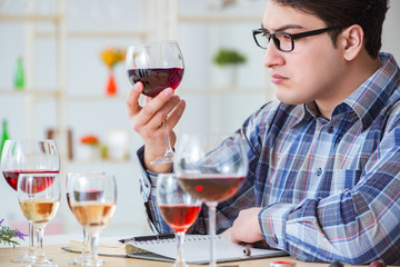 Professional sommelier tasting red wine 
