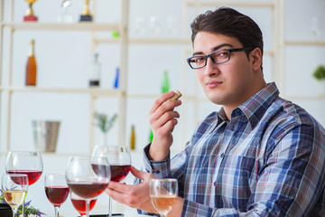 Professional sommelier tasting red wine 