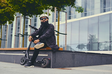 A man vaping after electric scooter.
