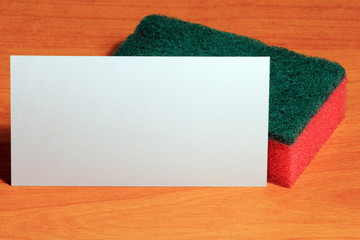 Cleaning sponge on wood background