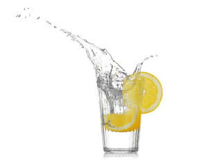 Fresh slice of lemon falling into glass with water on white background