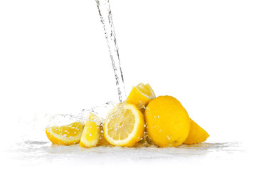 Fresh lemons with jet of water on white background