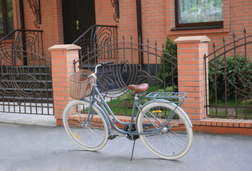 Obraz premium Bicycle with wicker basket on street