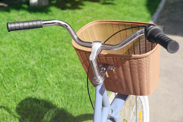 Bicycle with wicker basket on street