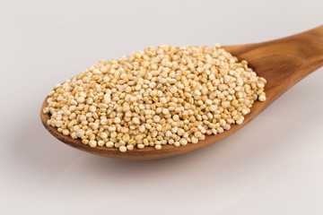 Pile of grain quinoa seeds in spoon