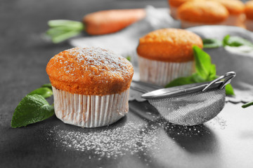 Composition with delicious carrot muffin on grunge table