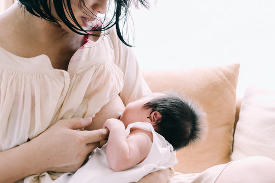 Mother Breastfeeding Her Newborn Baby Girl