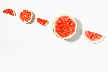 Slices of watermelon and grapefruit on white background. Flat lay