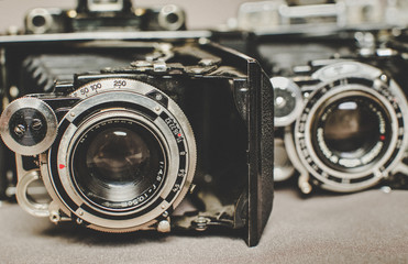 Old vintage retro camera still life on fabric background close up - Powered by Adobe