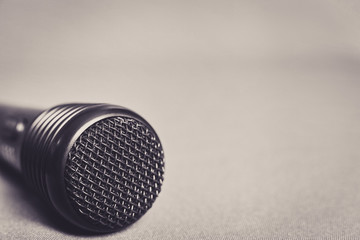 Microphone on fabric background with copy space close up