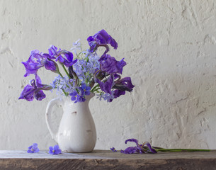 beautiful bouquet with irises on wooden table